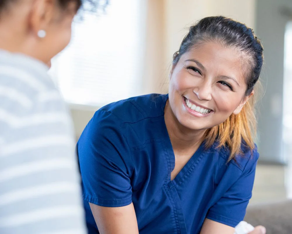 Healthcare nurse smiling at patient