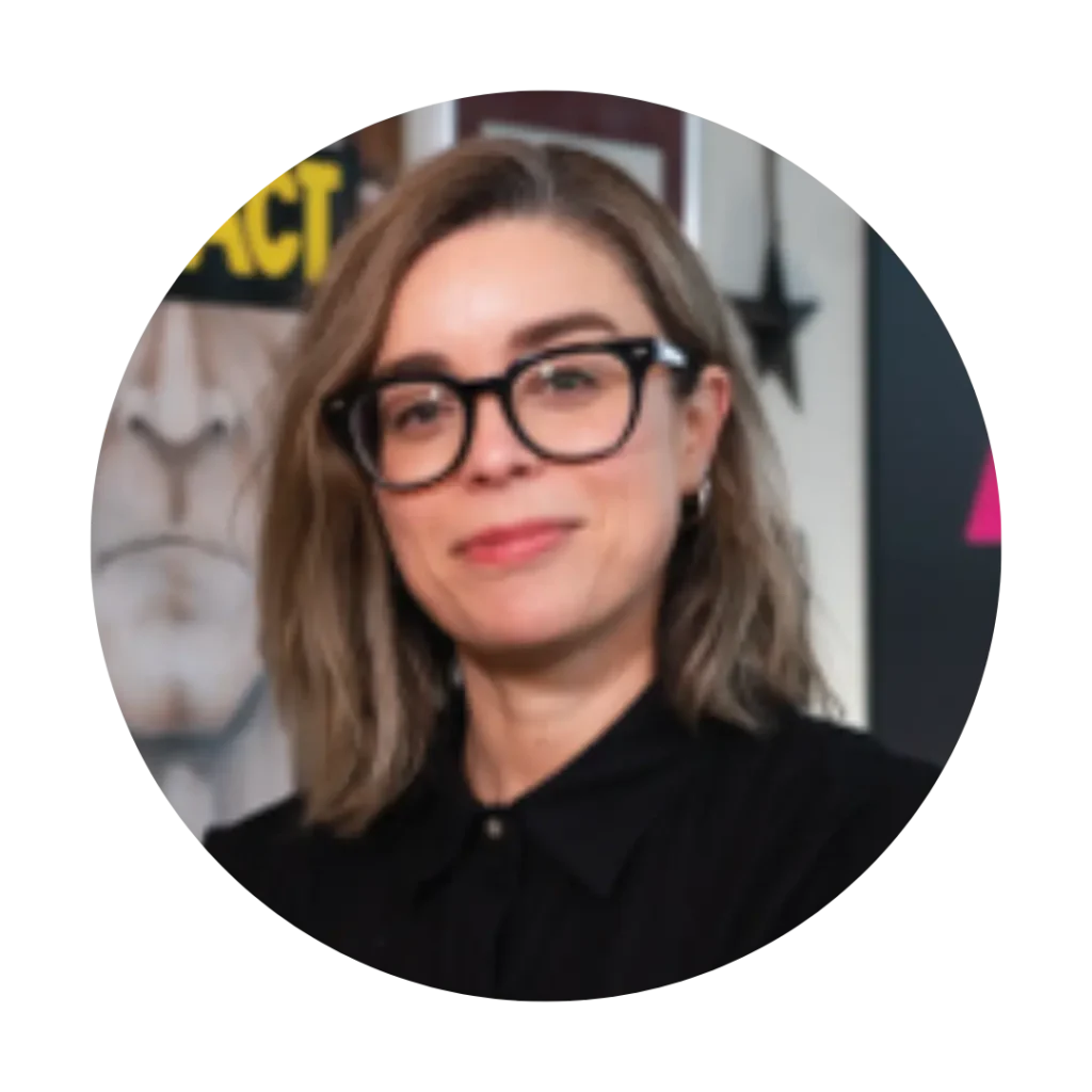 A headshot of Marilou Gagnon. Marilou has short hair, dark glasses, and wearing a black collared shirt.