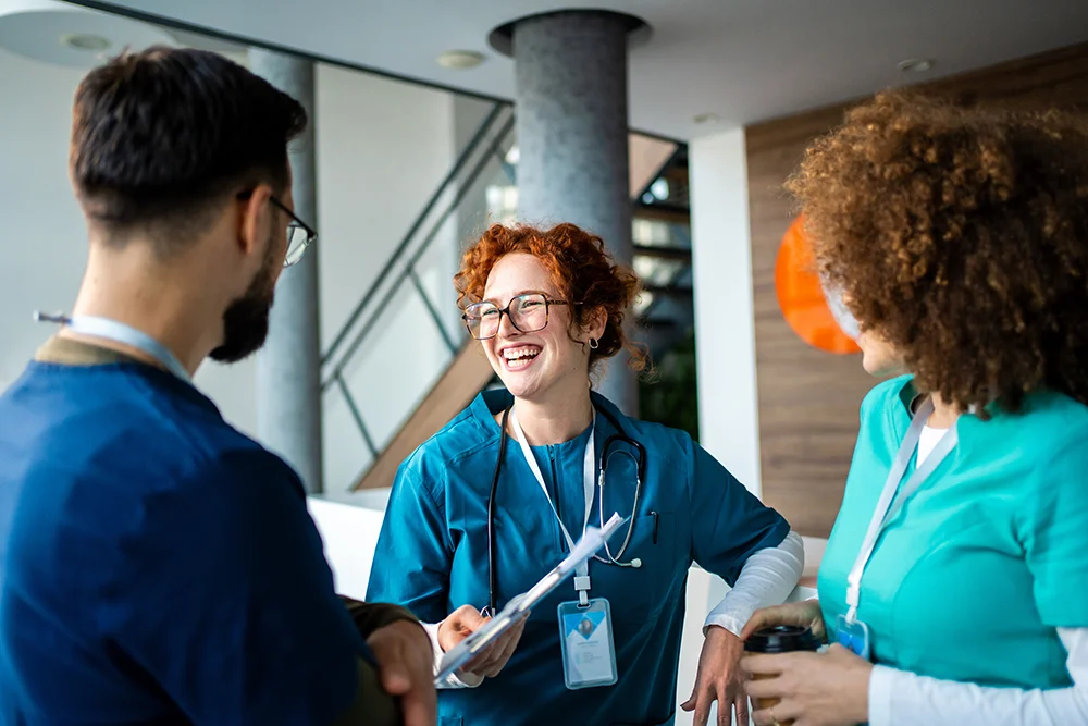 A group of nurses having a cheerful discussion during a work break.